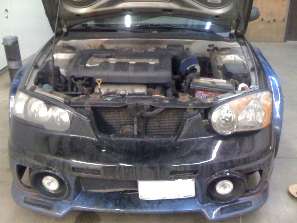 Hyundai Elantra front end with the hood open during body work