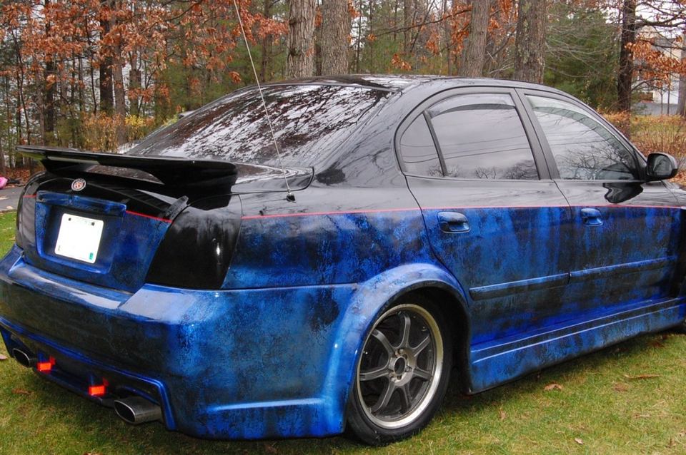 Rear three-quarter view of a Hyundai Elantra with custom blue marbled paint