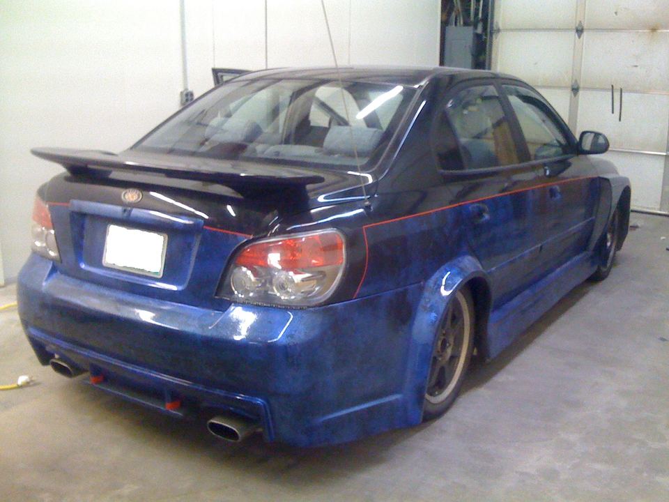 Hyundai Elantra rear in the shop with custom paint and spoiler