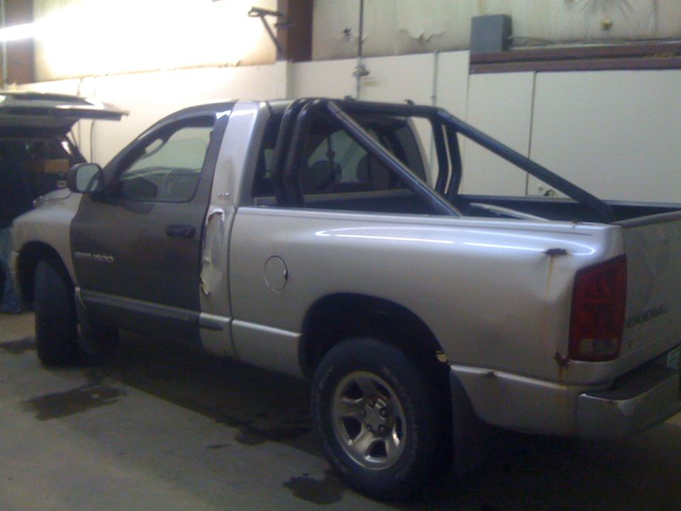 Silver Dodge Ram pickup in the shop before body work