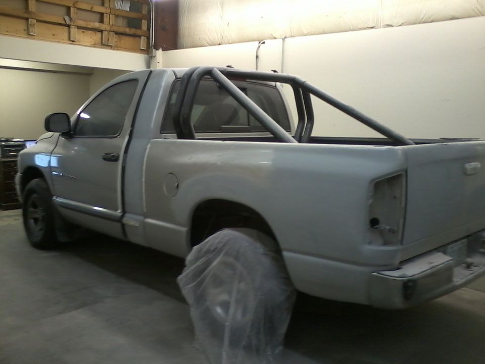 Dodge Ram pickup masked and primed in the paint booth