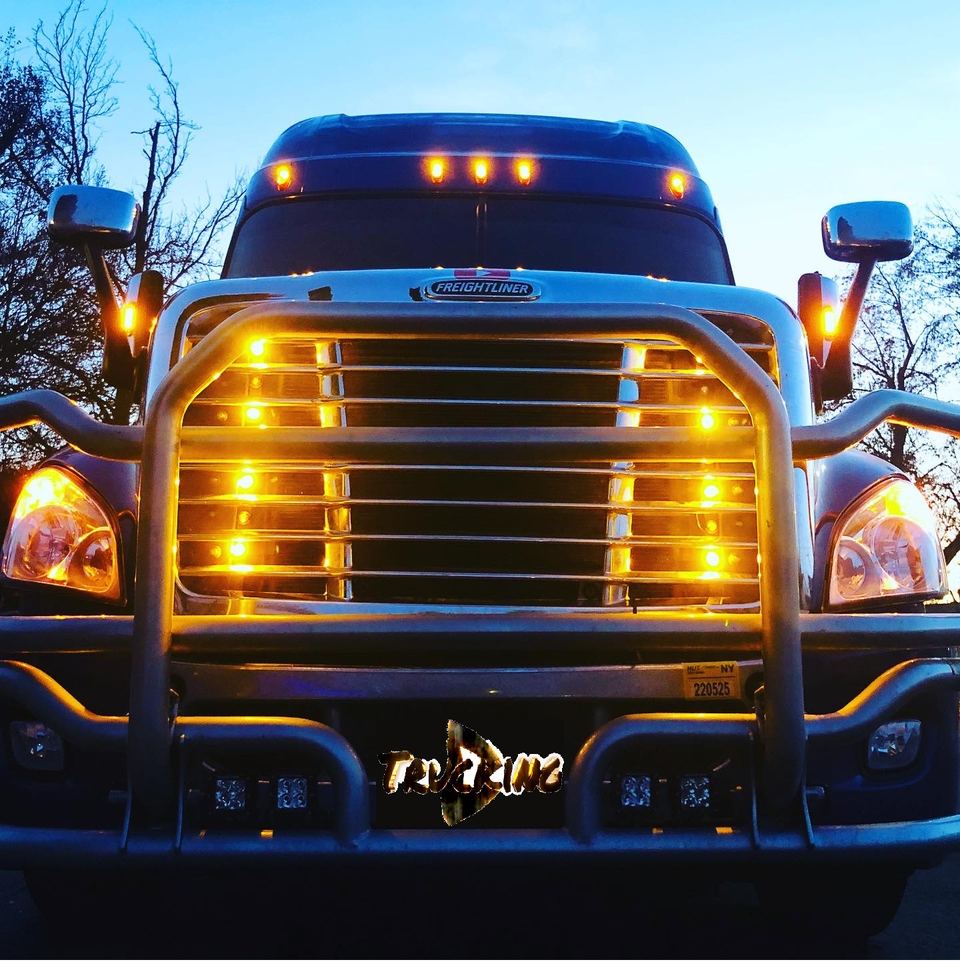 Chrome semi-truck grille lit with rows of amber LED lights