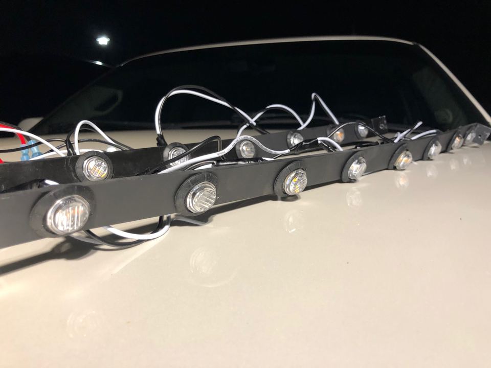 A pre-wired strip of LED marker lights laid out before install