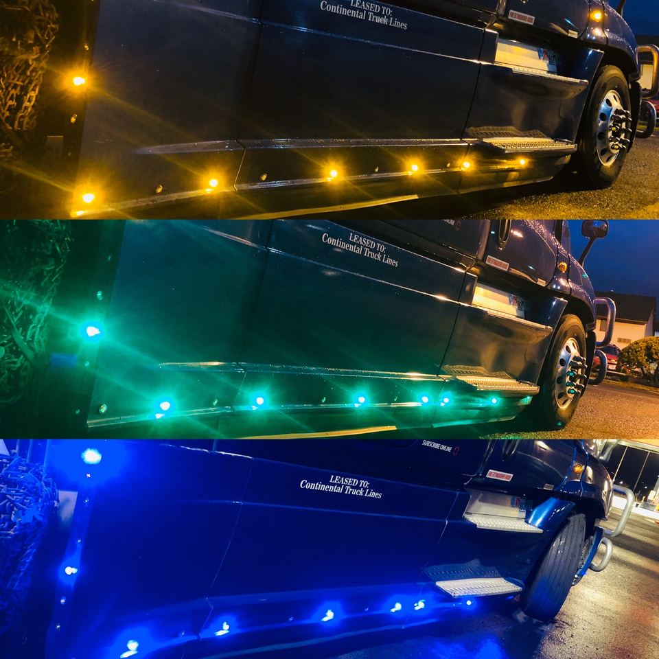 Semi-truck side skirt LEDs shown in amber, green and blue